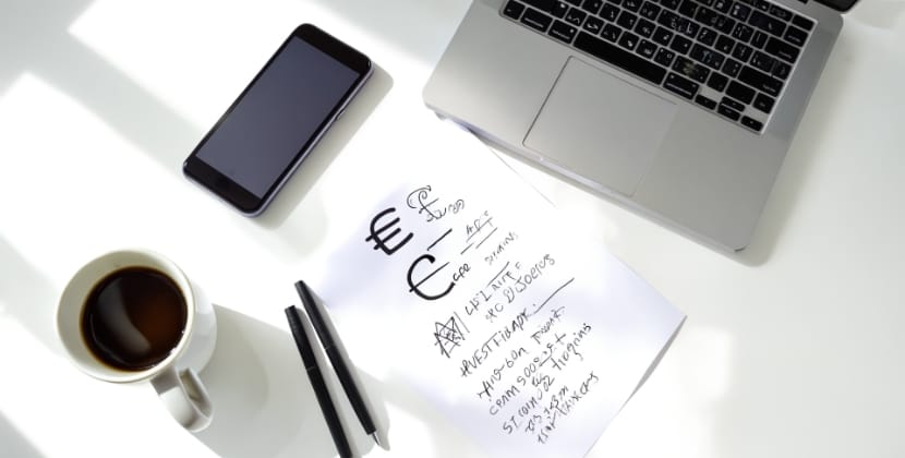 Workspace with handwritten notes on app development cost in the Netherlands