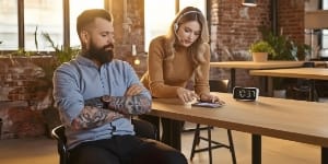 Support engineer with headset responding immediately at desk, phone lighting up — SLA rapid response