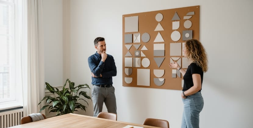 Website developer in a stand-up meeting comparing Drupal vs WordPress