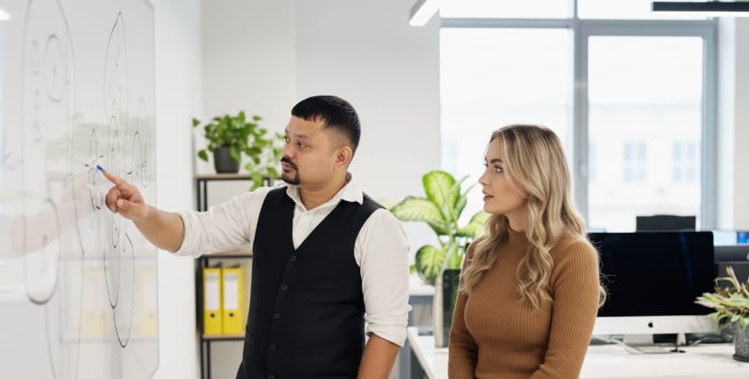 Modern office scene showing a UX planning moment for better conversion ownership.