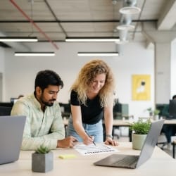 client review at laptop, discussing web design pricing details.