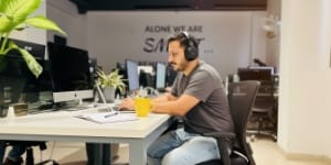 Pricing and rates, focused developer with headphones, planning web design pricing and timeline.