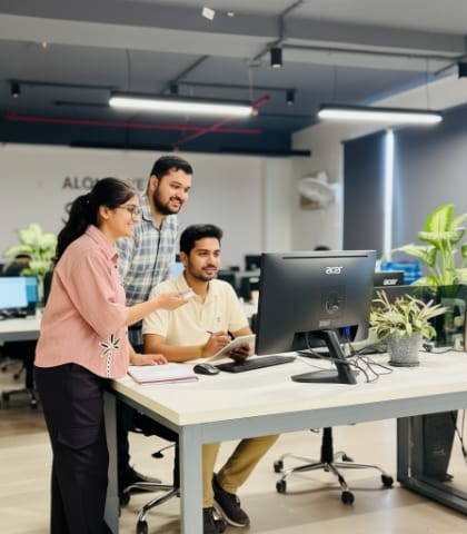 Team fit review at the monitor, checking scope and responsibilities.