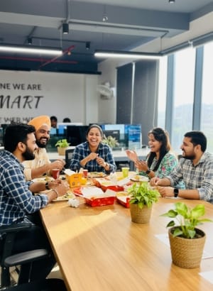 Team meeting around a table with snacks in a modern office