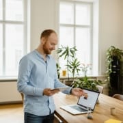 software development company reviewing a product flow on laptop and tablet, calm planning session