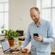 managed WordPress maintenance monitoring scene, on-call support workflow with laptop and phone