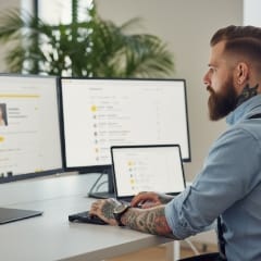 Recruitment website specialist reviewing ATS data next to a modern careers site