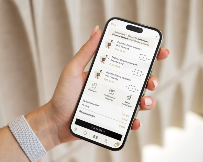 Hand met mobiele Elly Seidl-webshop, luxe chocolade webshop UX ontwerp door Studio Ubique
