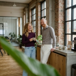 Two colleagues during a coffee break in the kitchen of the Zwolle industrial office, laughing conversation