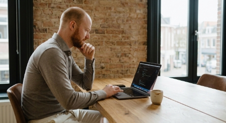 Studio Ubique developer working on structured data and AEO implementation at a Zwolle office desk