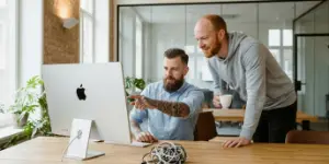 Two team members at a shared screen connecting a CMS to other tools, smart integrations