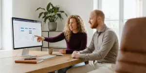 Two Studio Ubique designers reviewing a design system component library on screen.