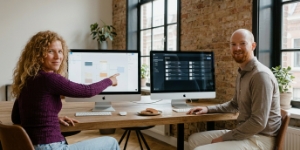 Two team members at a desk with a code editor on screen, design-to-dev efficiency