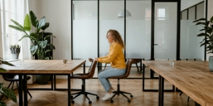 Working at a desk in the open-plan office, DevOps and deployment handoff