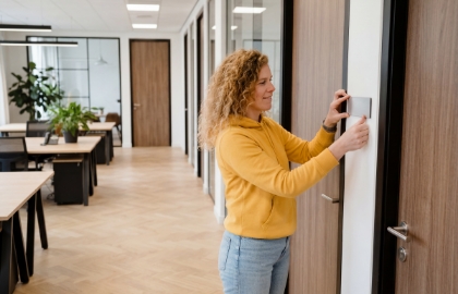 Studio Ubique team member at an office door panel in the hallway, illustrating domain registration