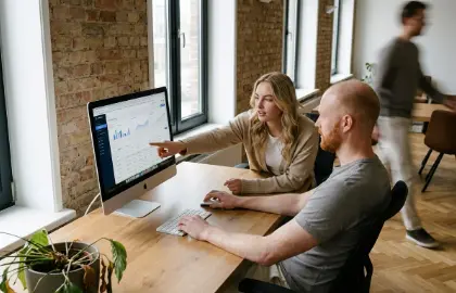 Studio Ubique team members reviewing an interface on screen in the Zwolle office, frontend development