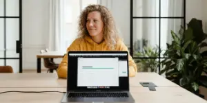 Studio Ubique team member working at a laptop at an office desk
