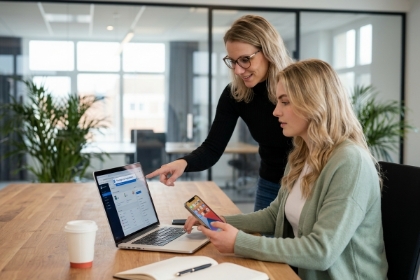 Two team members comparing an app on a laptop and a phone, progressive web app (PWA)