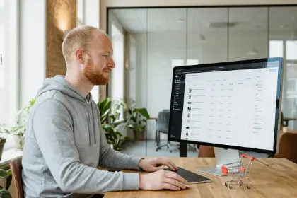 Team member at a store dashboard with miniature shopping carts, WooCommerce development