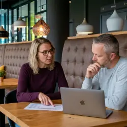 Twee collega’s van Studio Ubique nemen een websiteplan door in een zithoek op kantoor in Zwolle