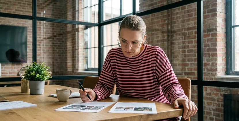 Shop owner comparing marketplace listing and own webshop product page side by side on a laptop