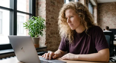 Website owner pausing with a finger over the trackpad before confirming a change in a site admin panel
